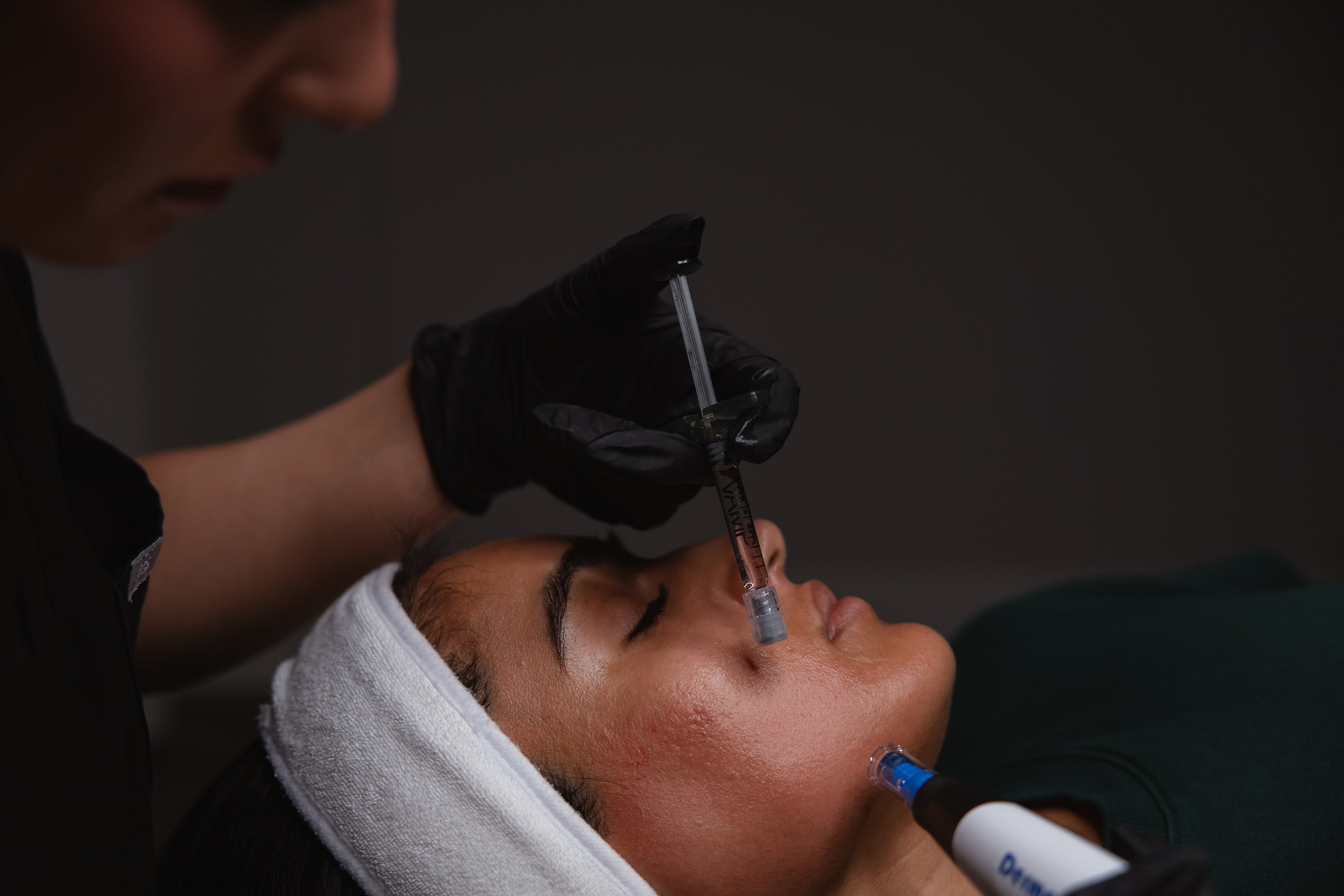 Close-up of a client receiving a facial injectable treatment with a syringe at KOZA Skin Clinic, Port Coquitlam, Tri-Cities BC.