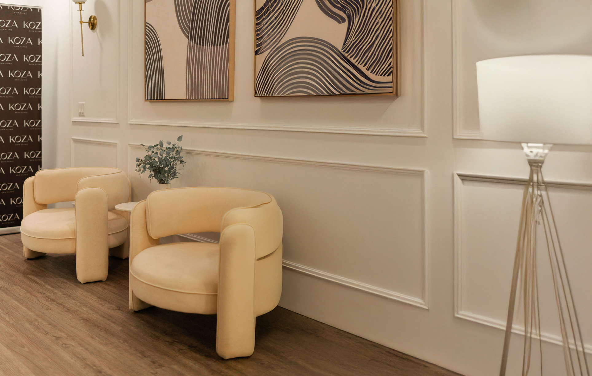 Interior of the waiting room with beige armchairs and wall art at KOZA Skin Clinic, Port Coquitlam, Tri-Cities BC