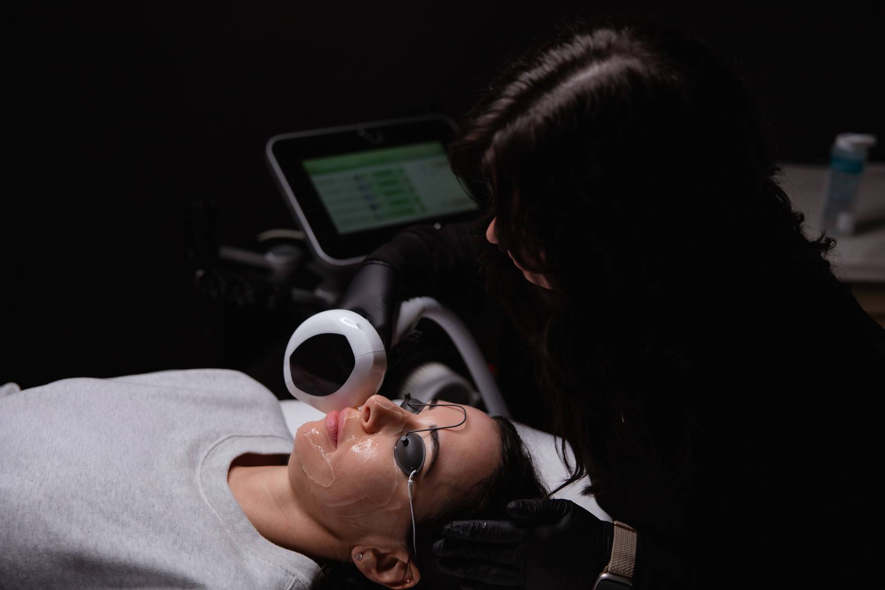 Client receiving a Lumecca IPL photofacial treatment on the face with protective eyewear at KOZA Skin Clinic, Port Coquitlam, Tri-Cities BC.