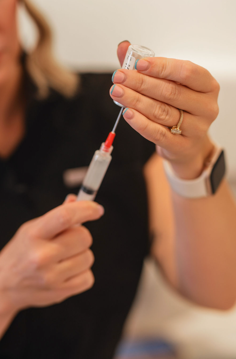 Clinician preparing a wellness injection from a vial into a syringe at KOZA Skin Clinic, Port Coquitlam, Tri-Cities BC.